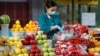 Kazakhstan - vendor wearing a protective face mask following an outbreak of the coronavirus disease (COVID-19) pack vegetables at a local food market, also known as bazaar, in Almaty, Kazakhstan March 20, 2020. REUTERS/Pavel Mikheyev